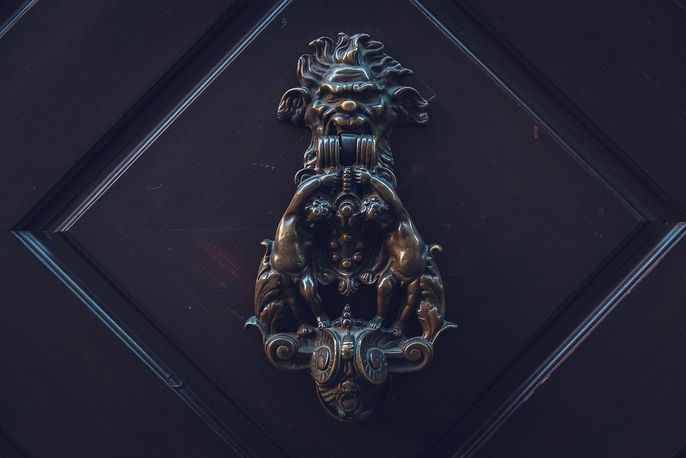 Dark colored Victorian designed door knocker