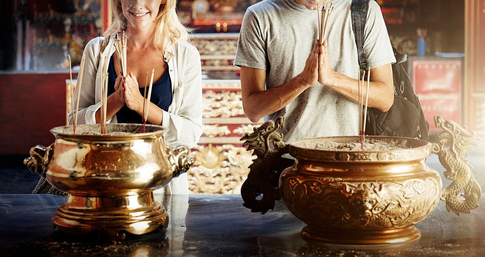 Caucasian couple is praying in the temple