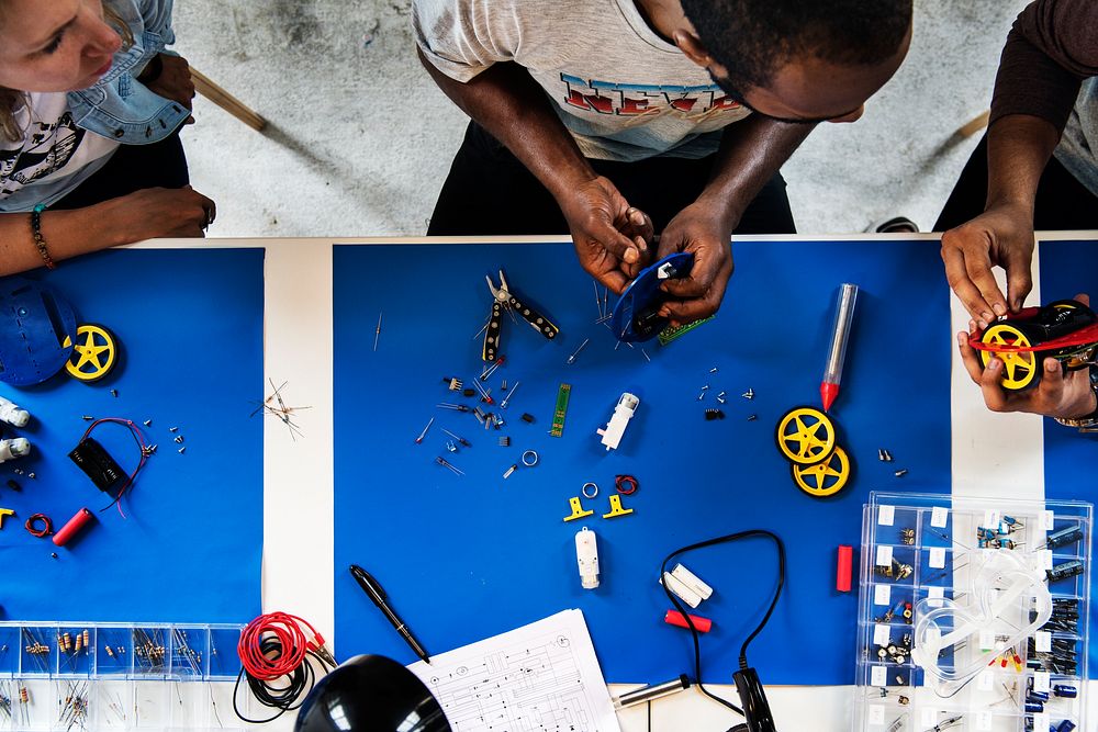 An aerial view of people working together in a mechanical workshop