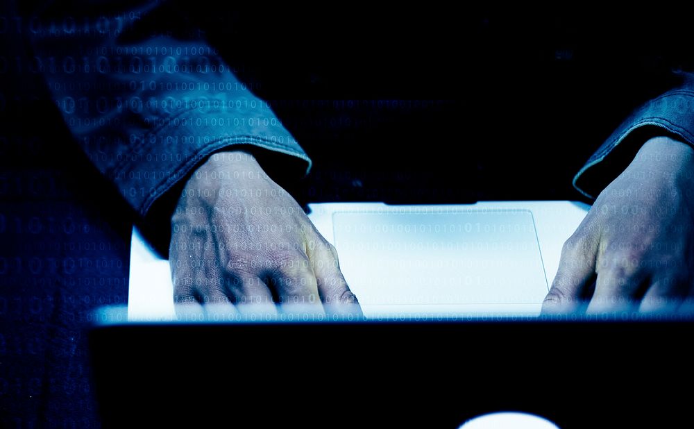 Closeup of hands working on computer laptop