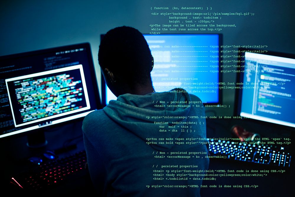 Computer hacker using three computers