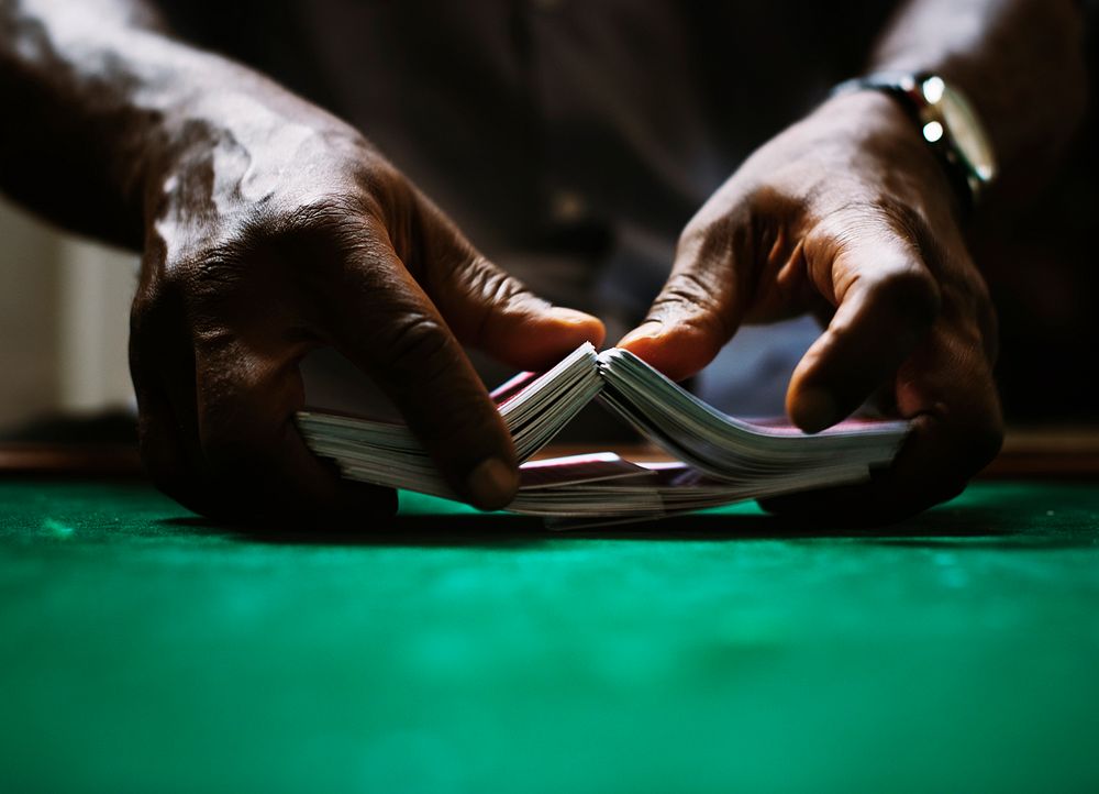 Dealer shuffling a deck of cards in casino