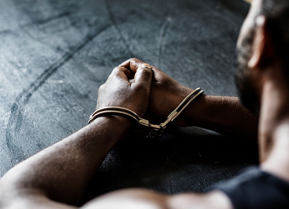 Arrested man with handcuffs on wrists