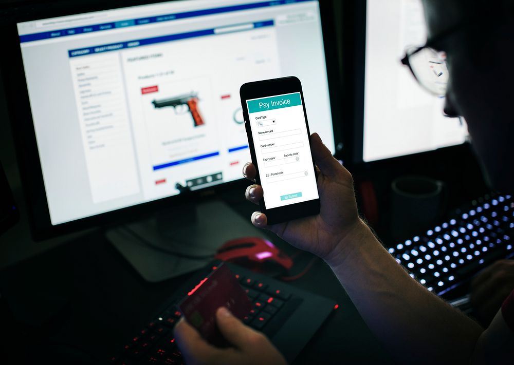 Closeup of man making online order of gun