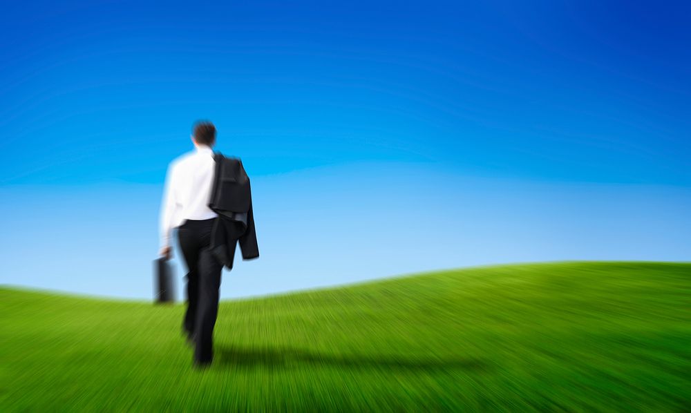 businessman walking on the hill