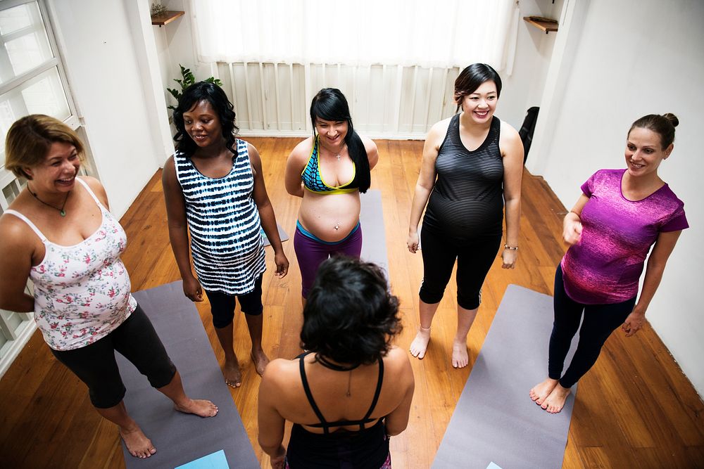 Pregnant woman in yoga class