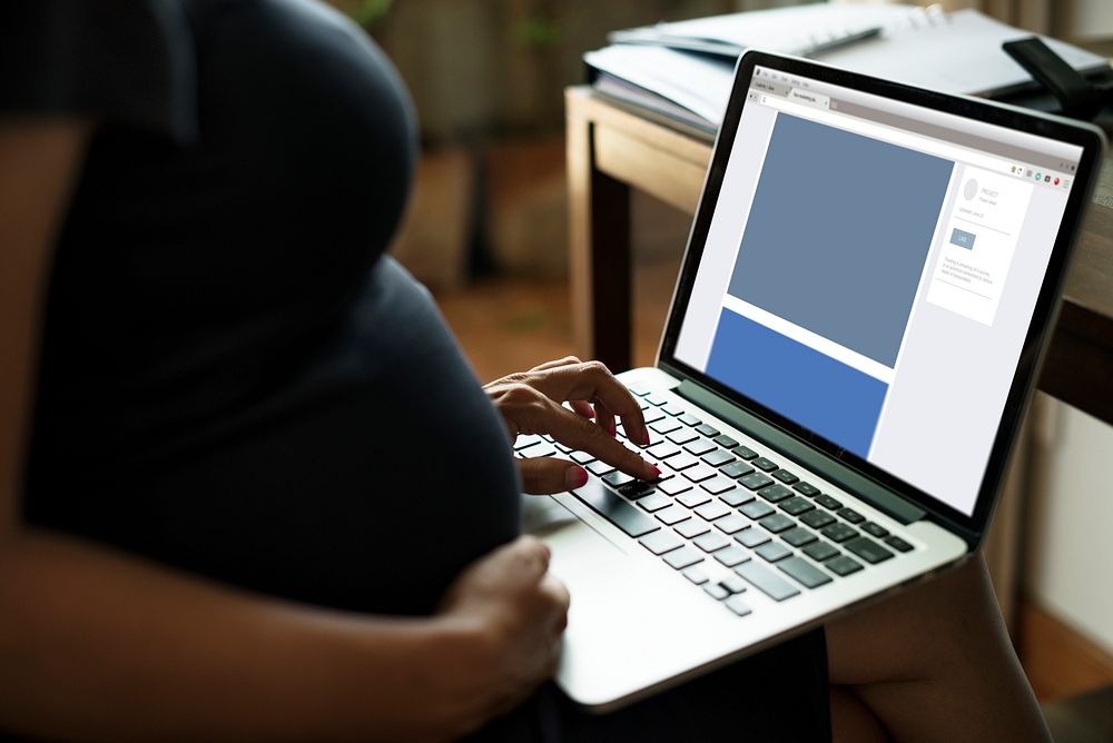 Pregnant woman is using computer laptop