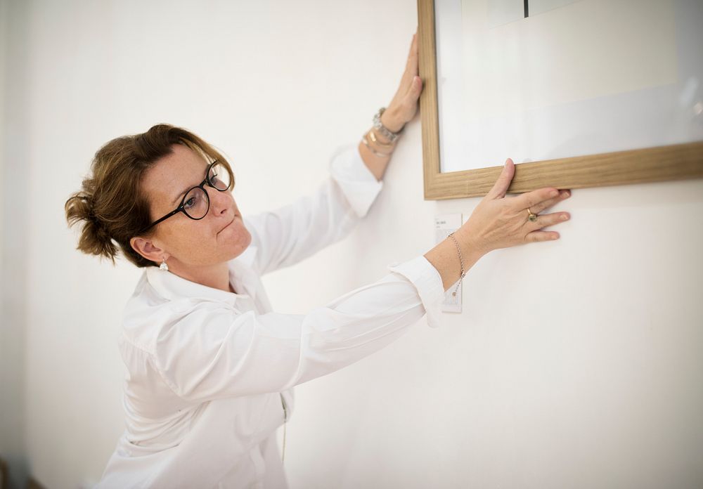 Woman adjusting the photo frame