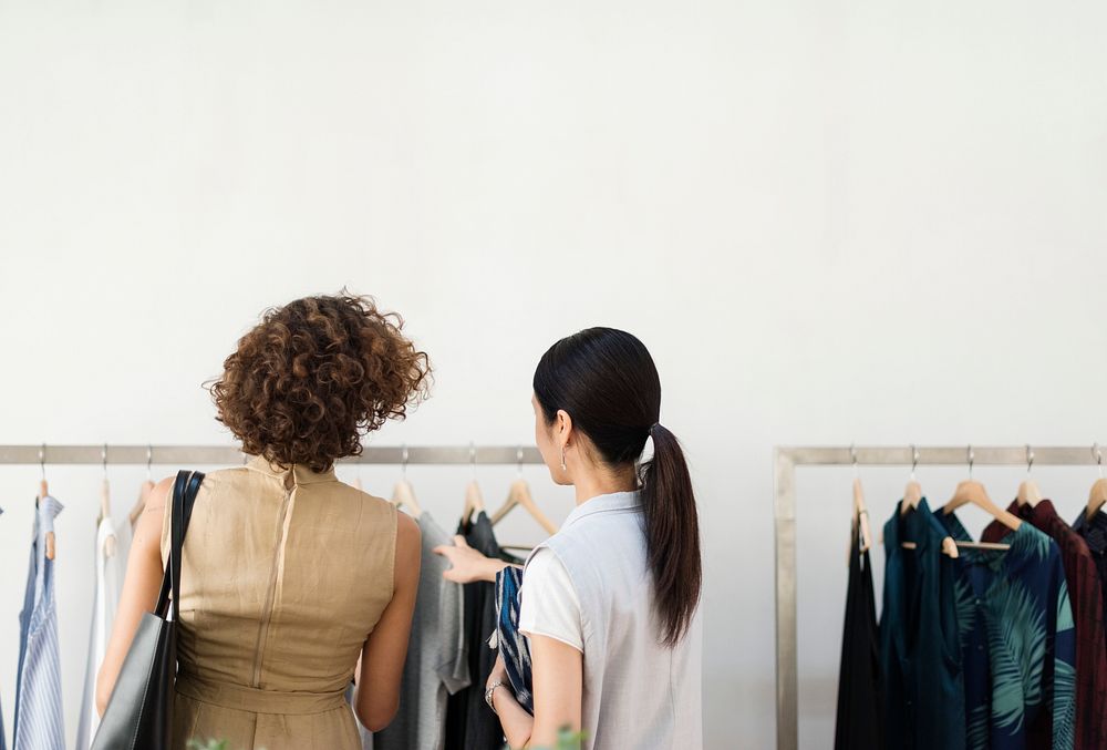 People choosing cloth from the rack | Photo - rawpixel