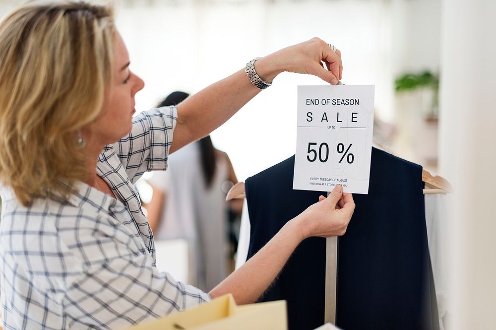 Woman with 50 percent sale sign