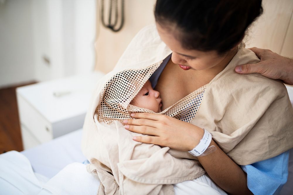 Mother breastfeeding to newborn baby