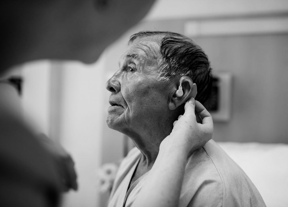 Elderly man wearing hearing aid