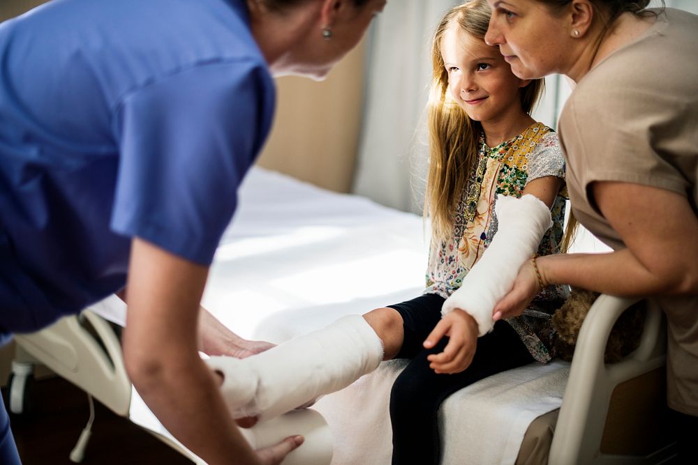 Young Caucasian girl with broken arm in plaster cast