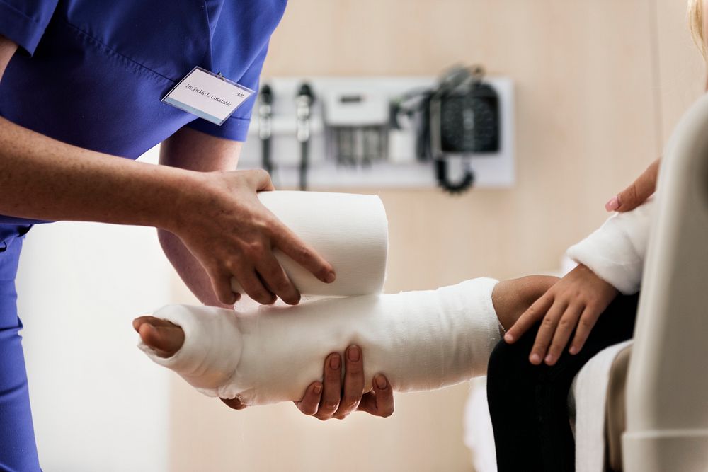 Young Caucasian girl with broken leg in plaster cast