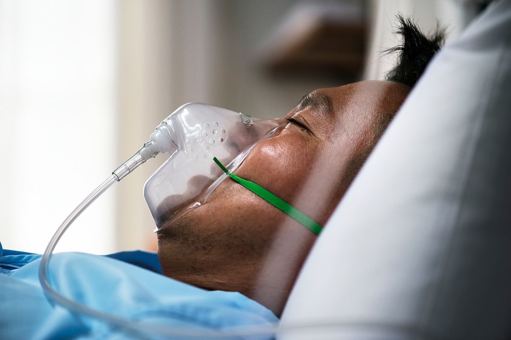 A sick Asian man in a hospital