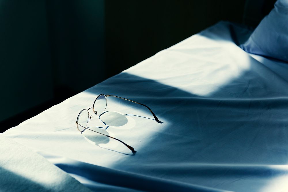 Eyeglasses on a bed