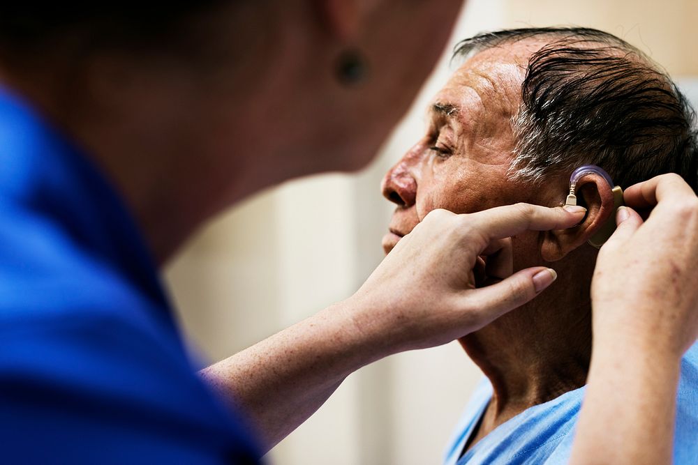 An old man wearing hearing aids