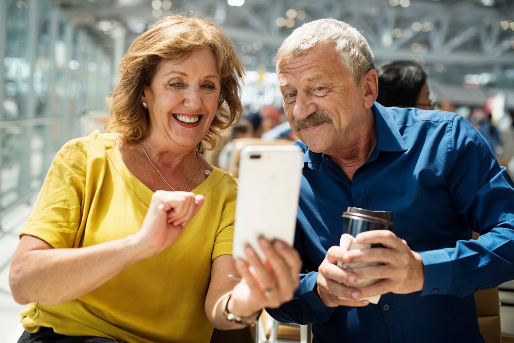 Caucasian couple is using digital device