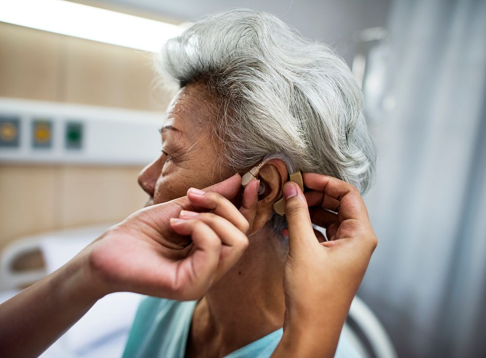 Asian old woman having her ears checked