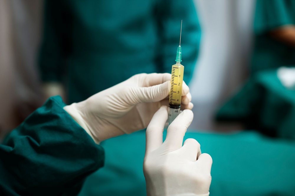 Doctor preparing a syringe shot