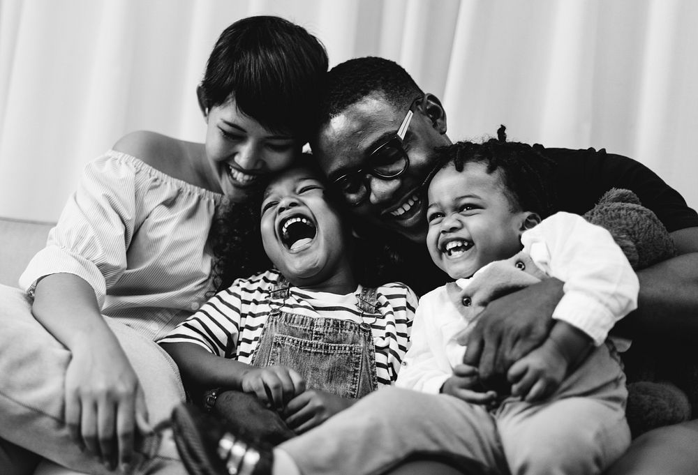 Young cheerful black kid with family
