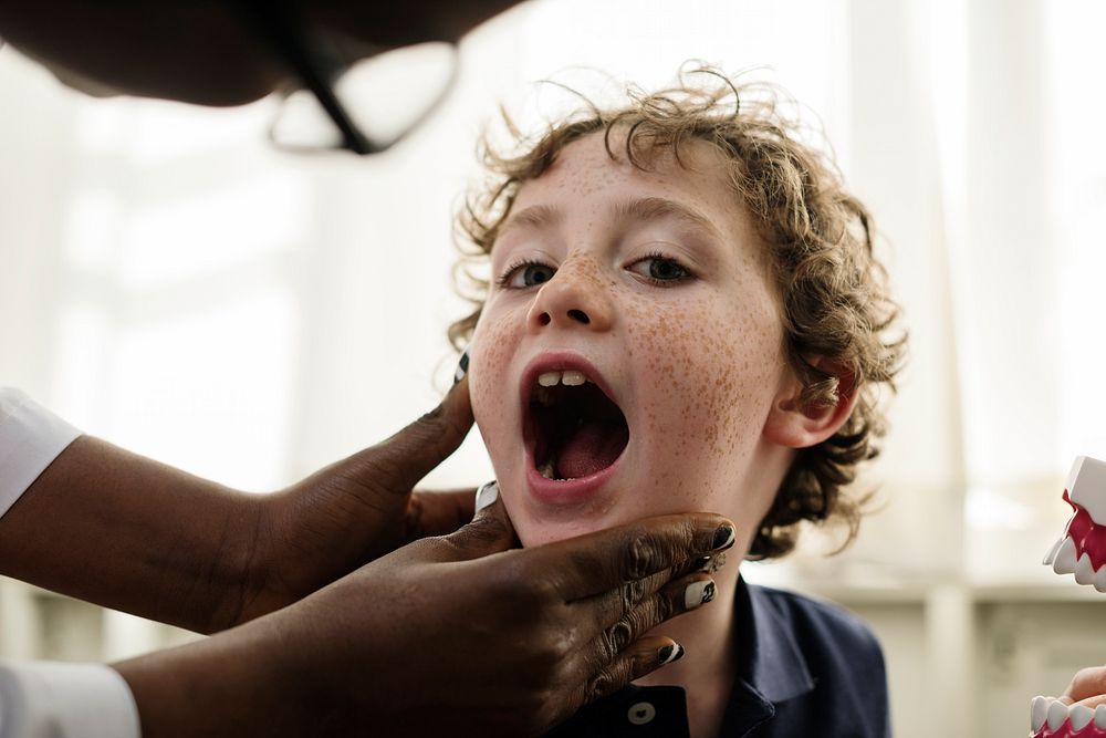 Young boy having his teeth checked