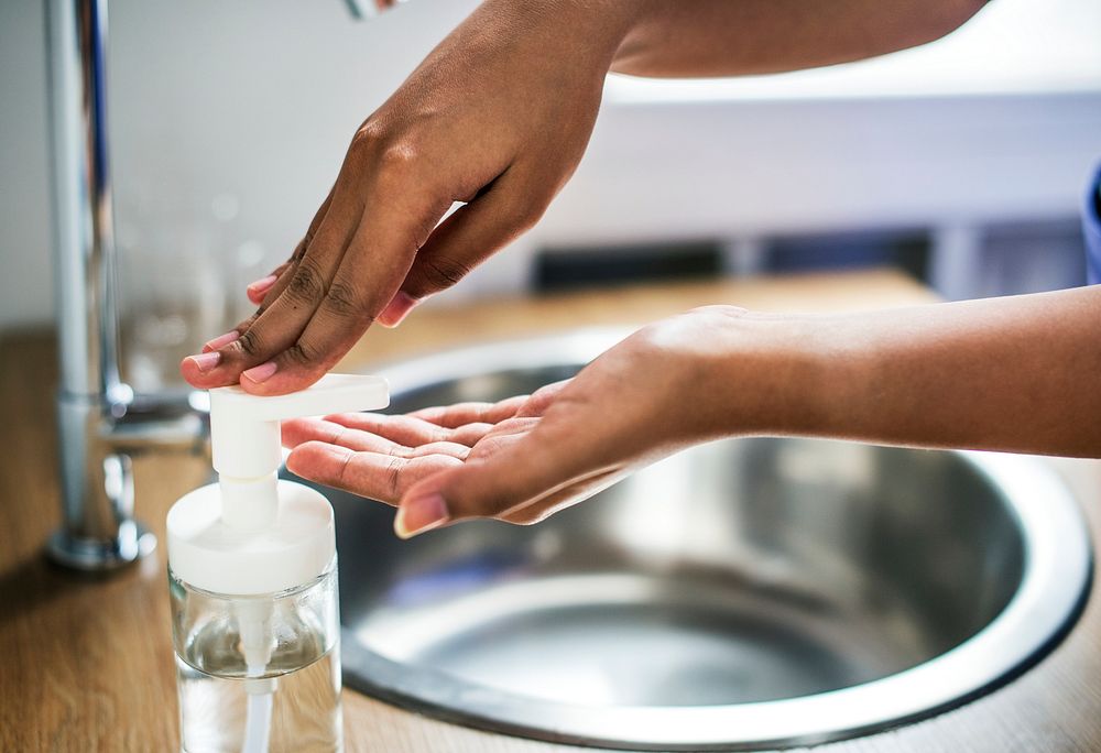 Closeup of hands washing with sanitize solution