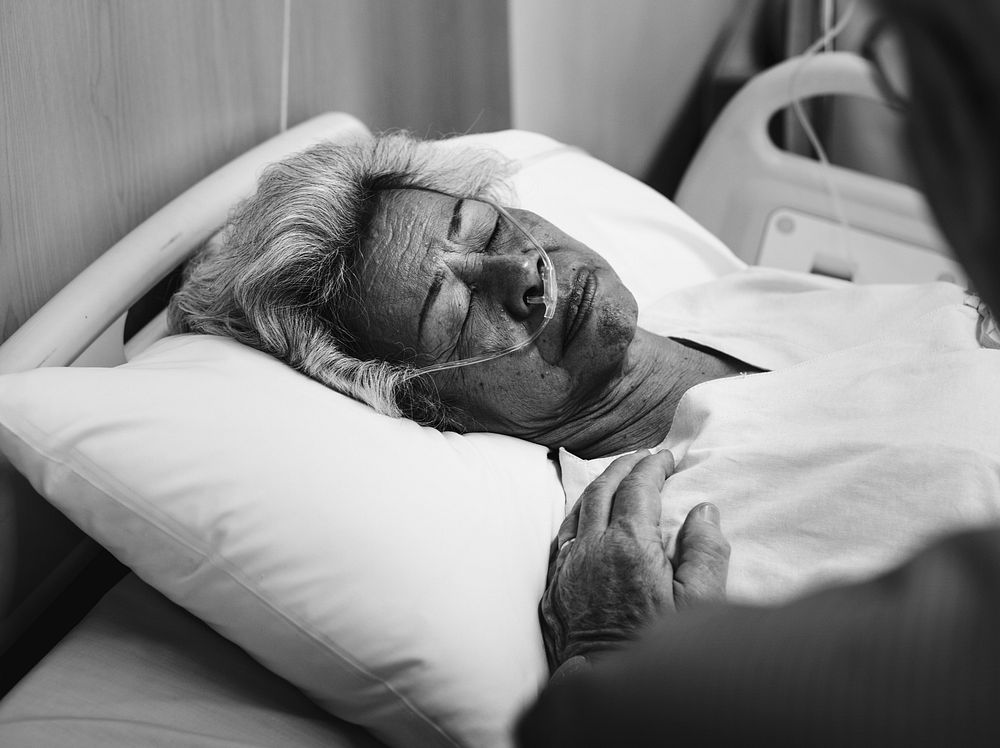 Old patient in a hospital bed