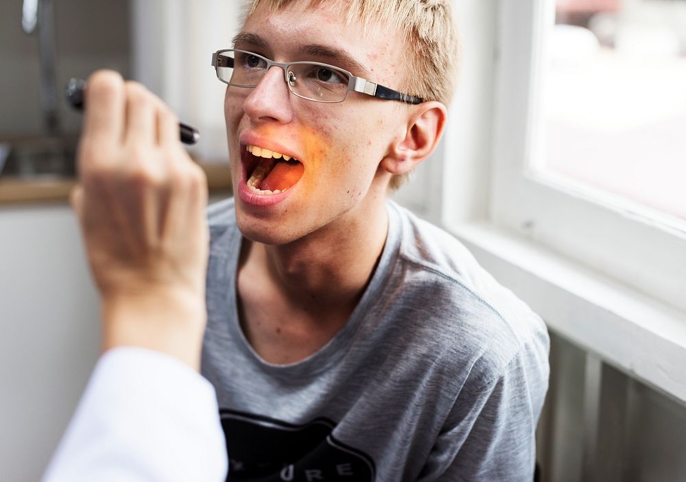 Young man having his teeth checked