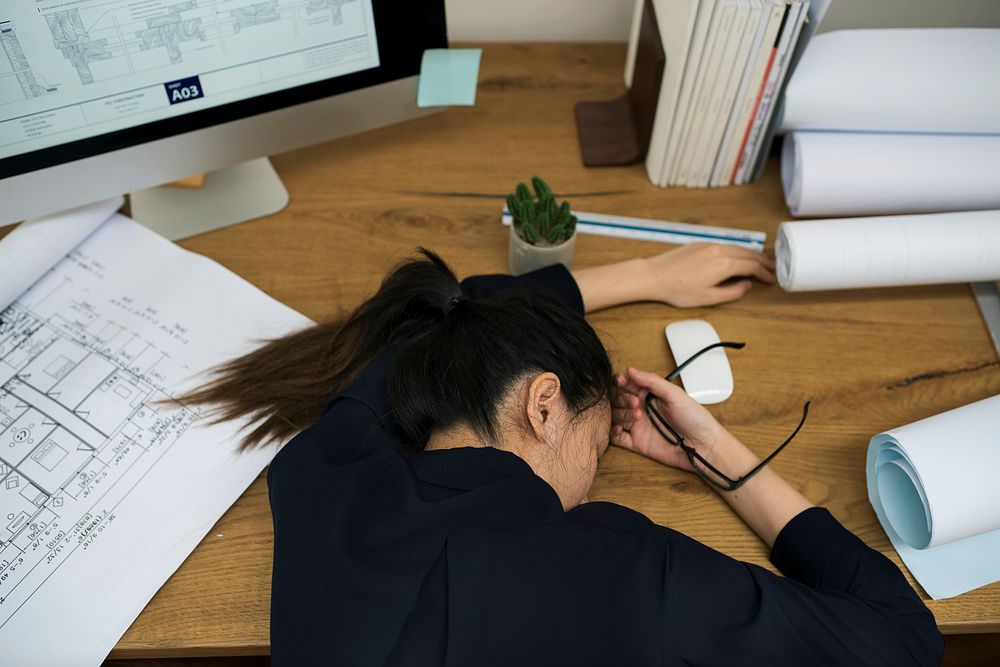 Businesswoman stressed and tired sleeping at the desk