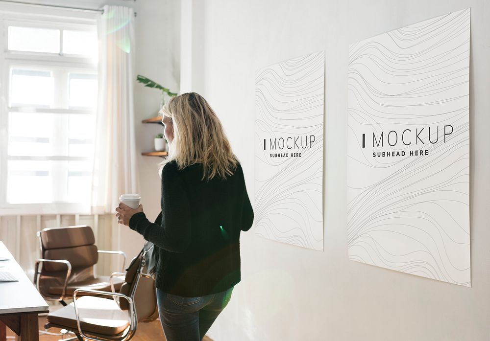Woman in a working space with poster design mockups