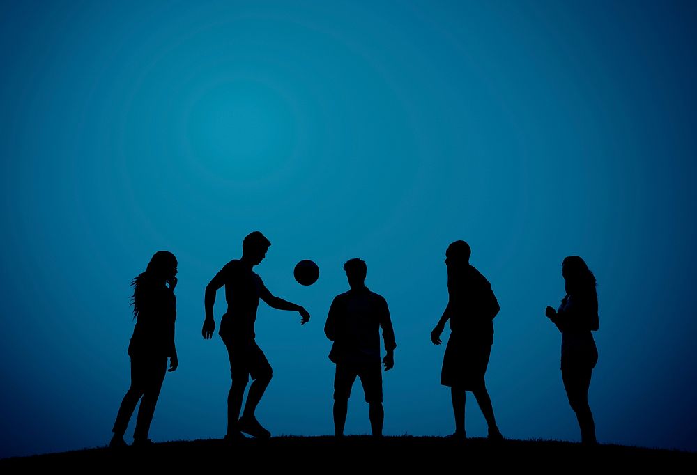 People playing football on a hill