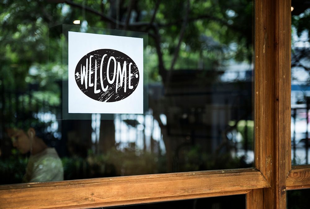 Welcome sign on a glass window