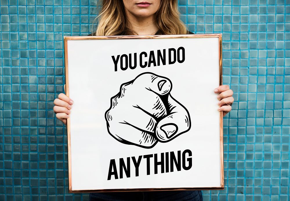 Woman holding picture frame with phrase