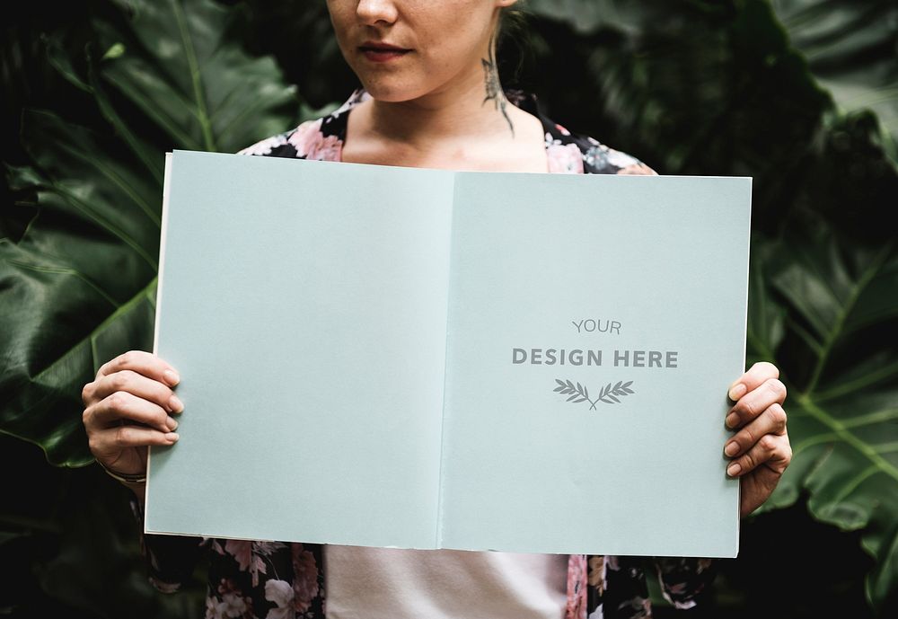Woman holding design space pages of magazine