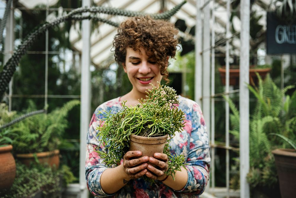 Woman holding a pot of plants