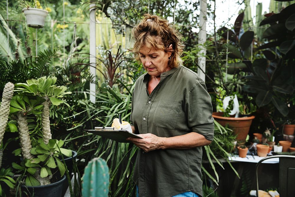 Woman gardening in a green house