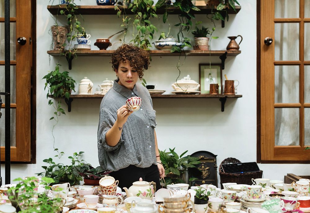 Woman choosing some tea cups