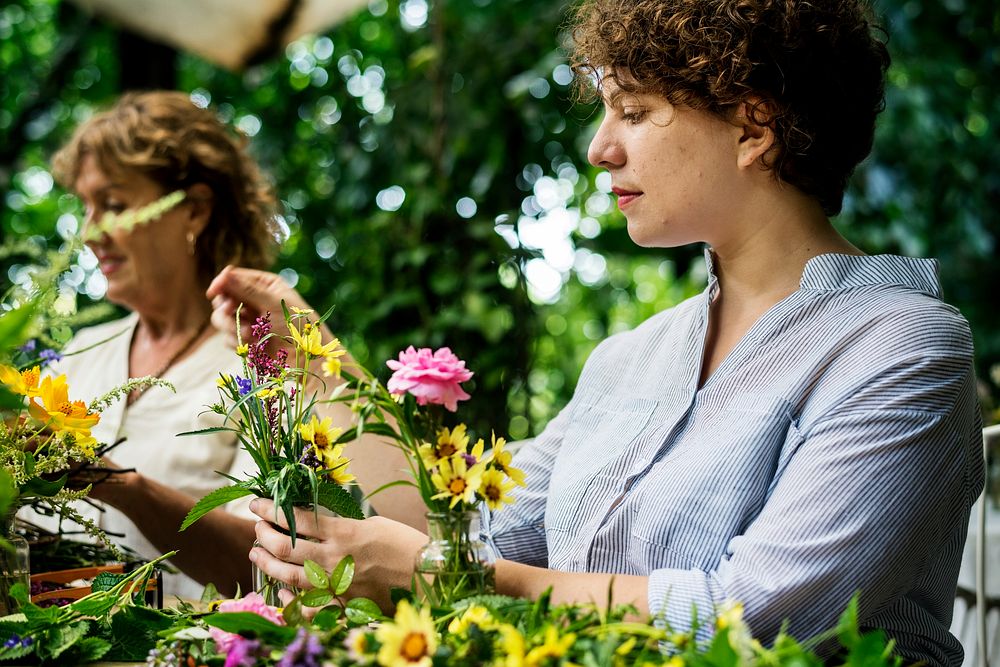 Women arranging flowers with her friend