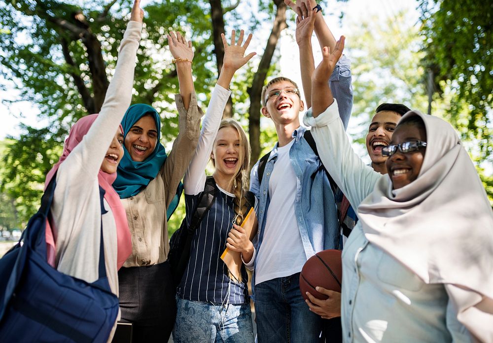 Cheerful Diverse teenagers with friends in a park