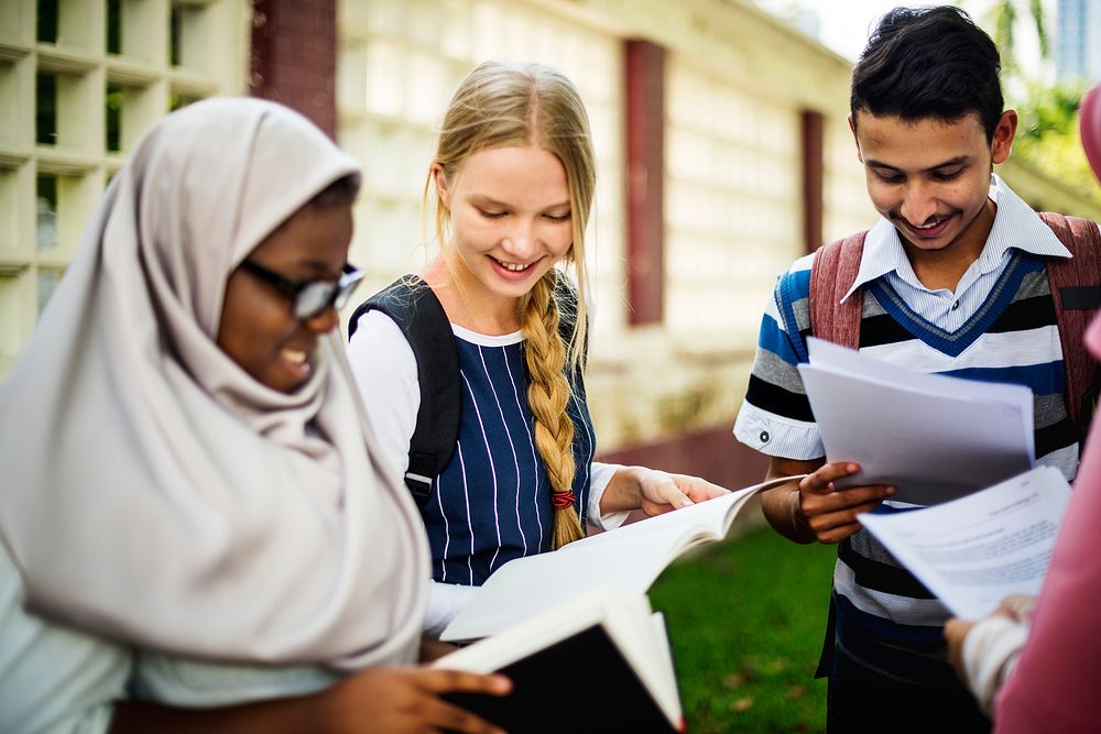 Diverse children studying together in a park