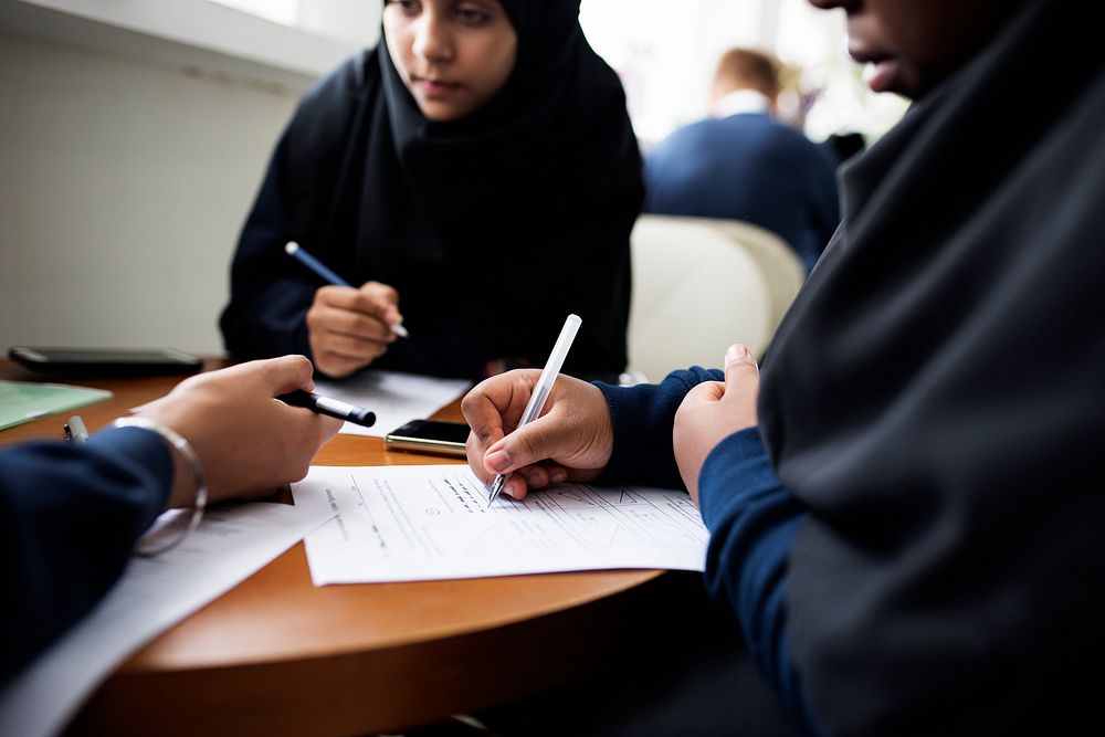 Diverse Muslim girls studying in a classroom together