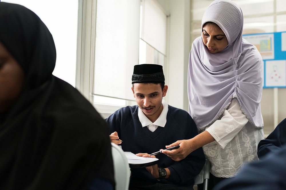 diverse muslim children studying in classroom