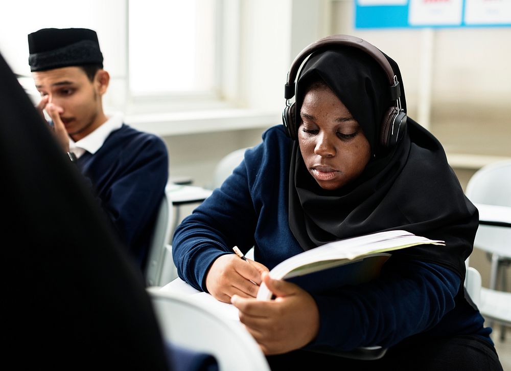 Diverse muslim children studying in classroom