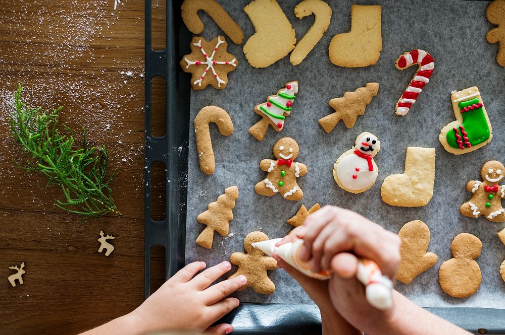 Gingerbread cookies getting decorated for Christmas