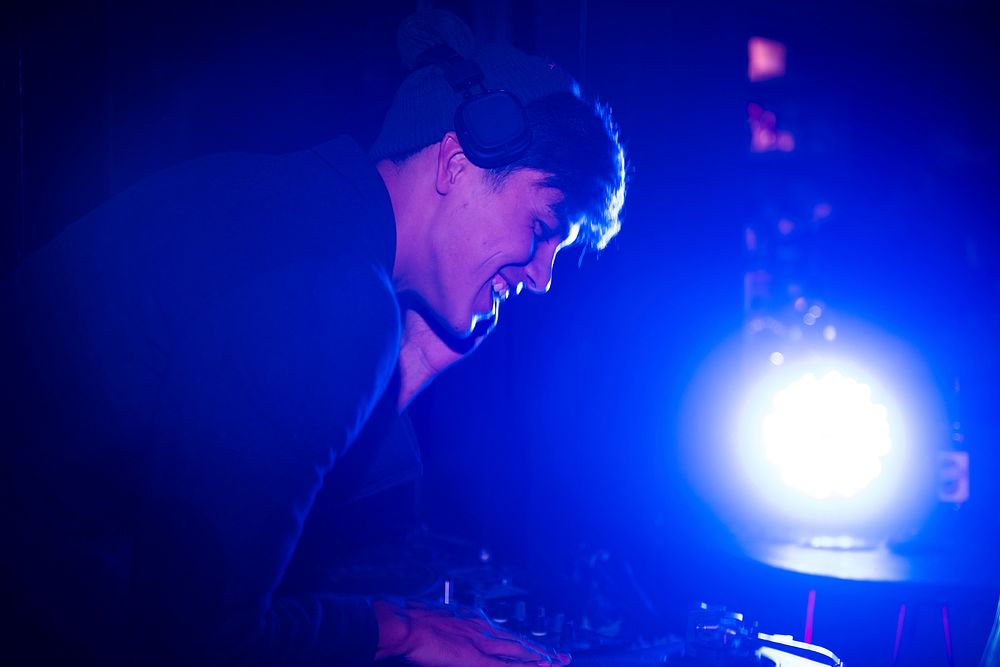 DJ playing music in a night pub