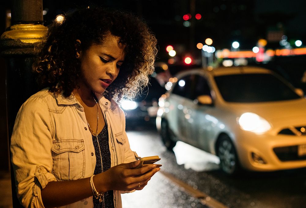 Woman on a road using mobile phone