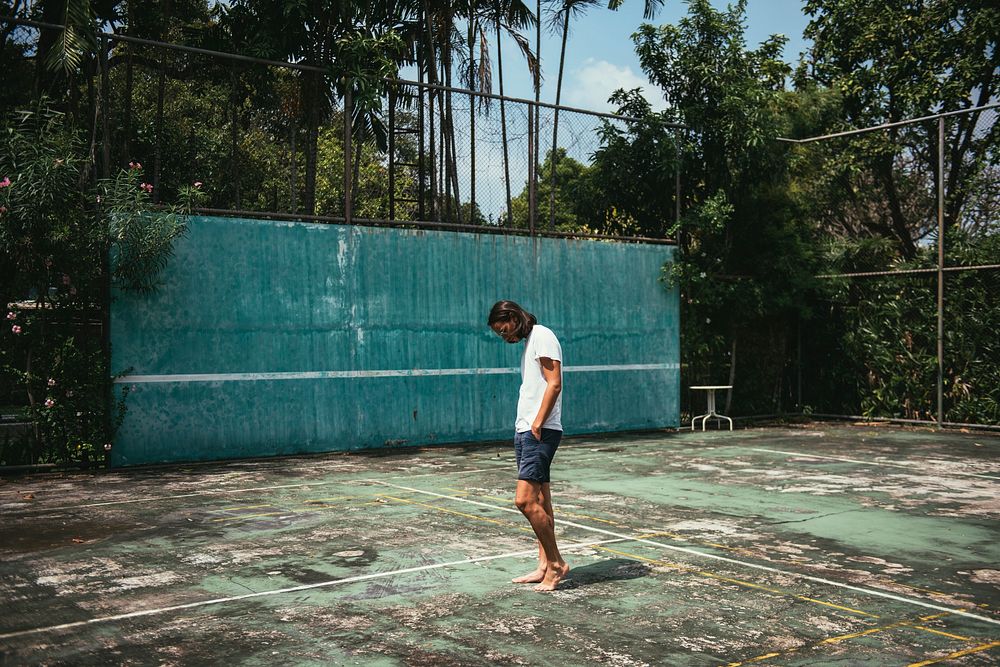 Man standing in a tennis court