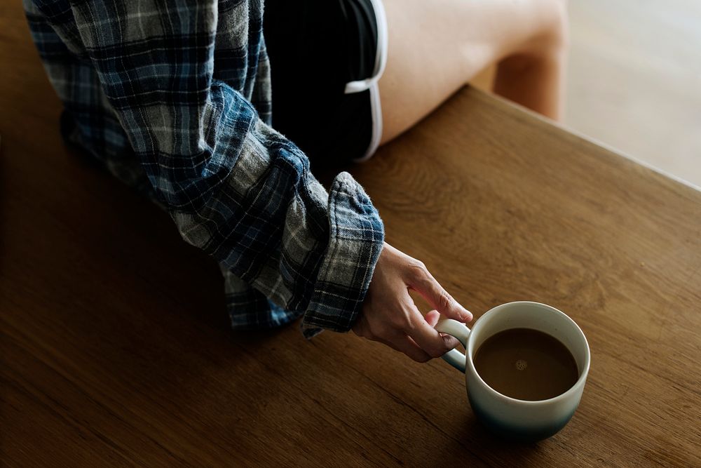 Woman's hand relaxing with a cup of coffee