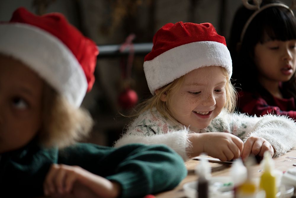 Adorable cheerful little girl wearing a santa hat